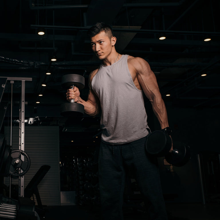 Man lifting a barbell in a gym setting