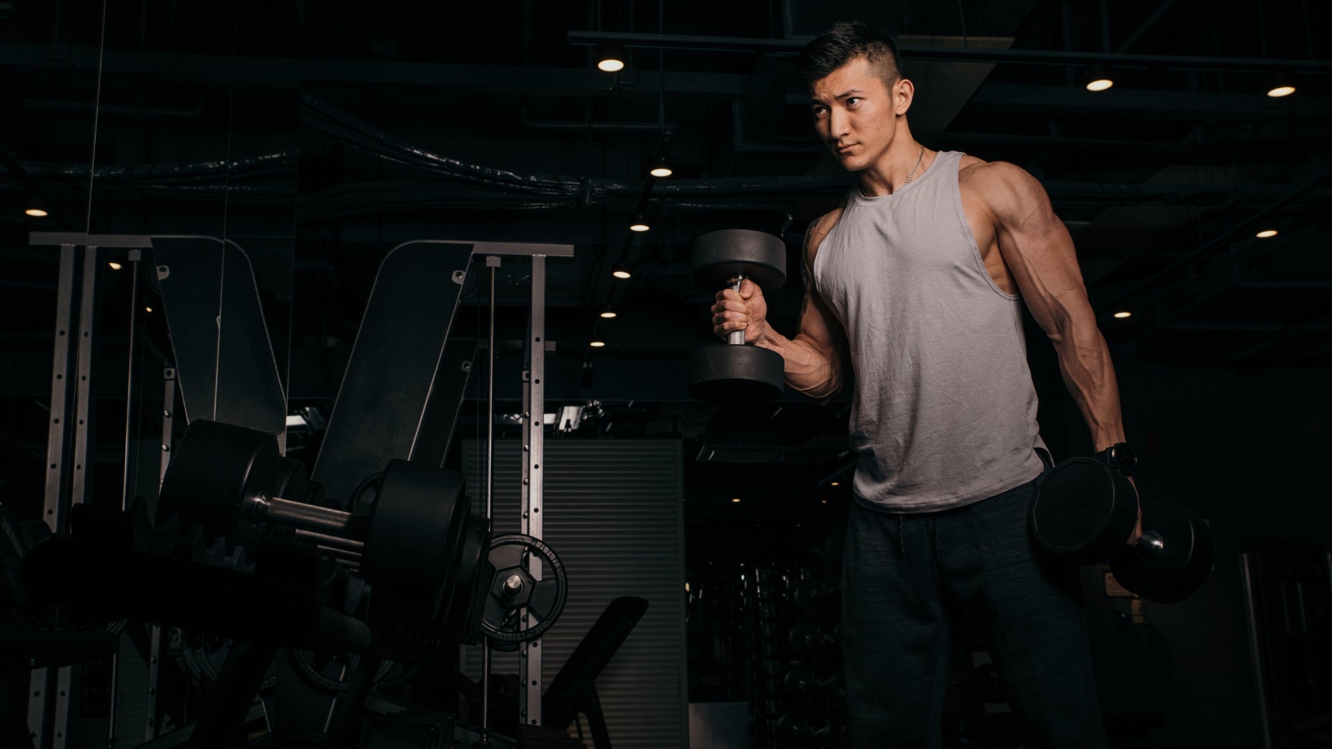 Man lifting a barbell in a gym setting